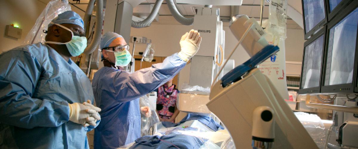 2 surgeons in scrubs doing surgery