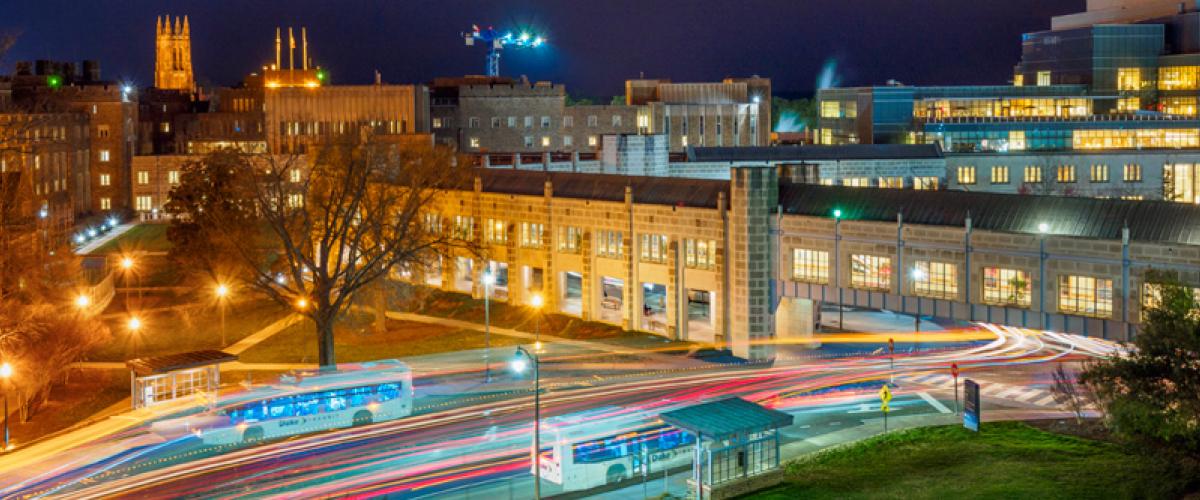 Duke South Clinic at night, the newly lit Duke Chapel in the background