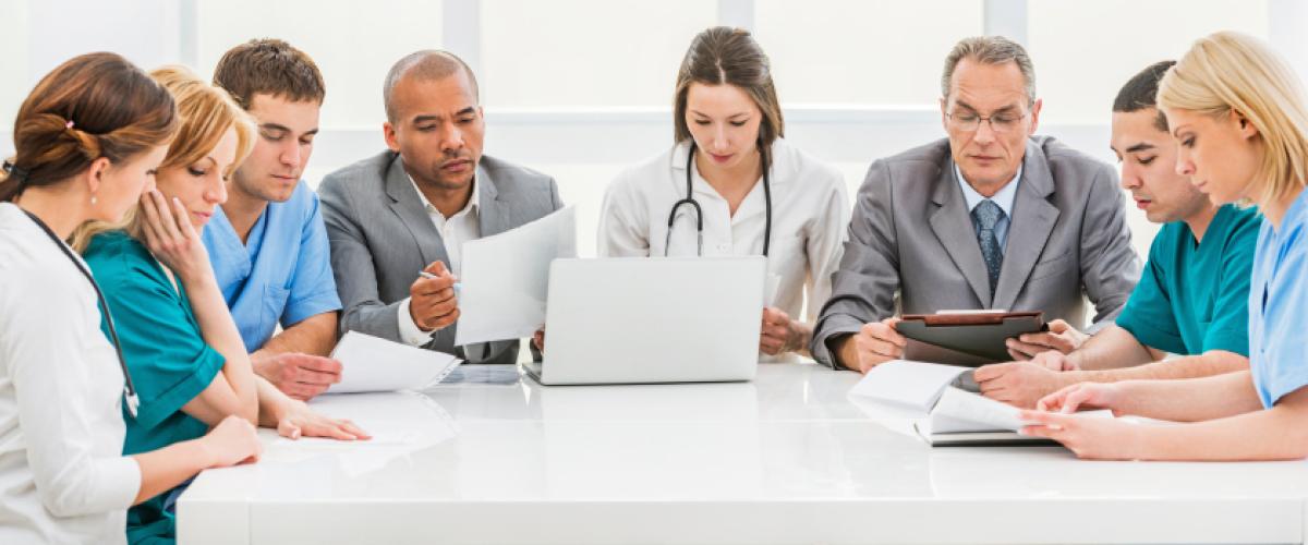 Group of 8 people sitting around a table